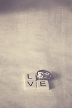 word love in wedding bands and scrabble pieces 