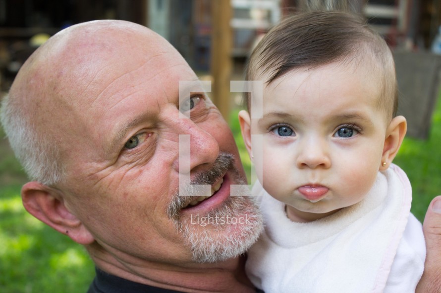 grandfather holding his infant granddaughter 