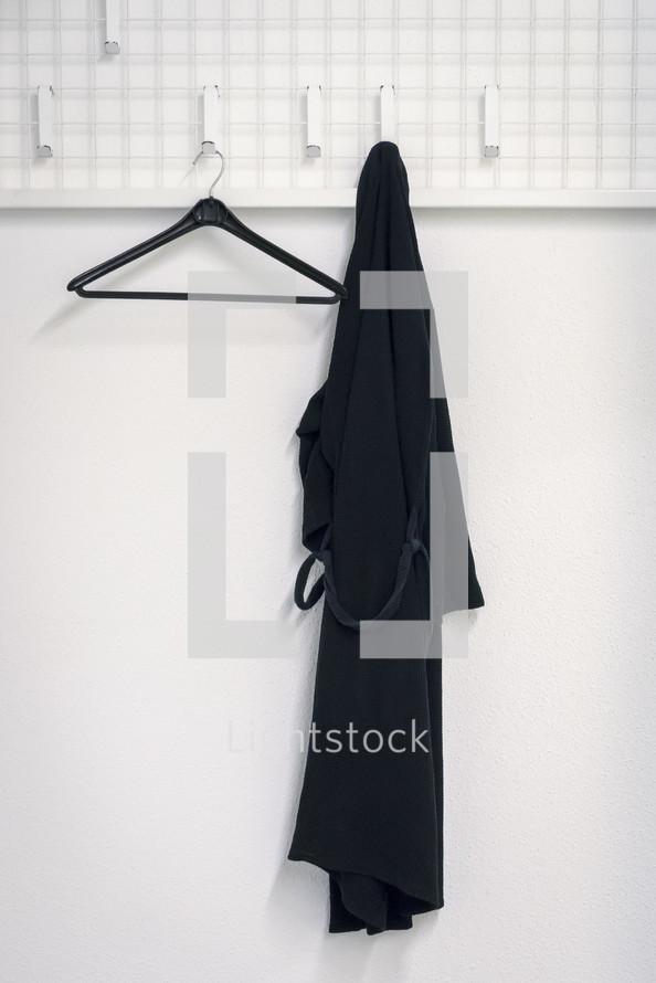 black rope hanging on a hook in a bathroom 