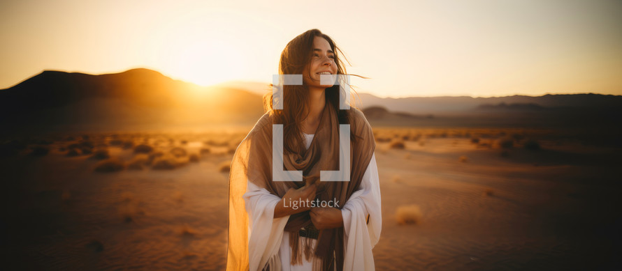 Happiness. Beautiful woman, smiling, in a desert at sunset