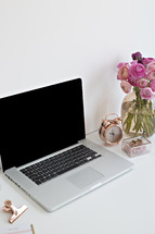 roses in a vase and laptop computer 