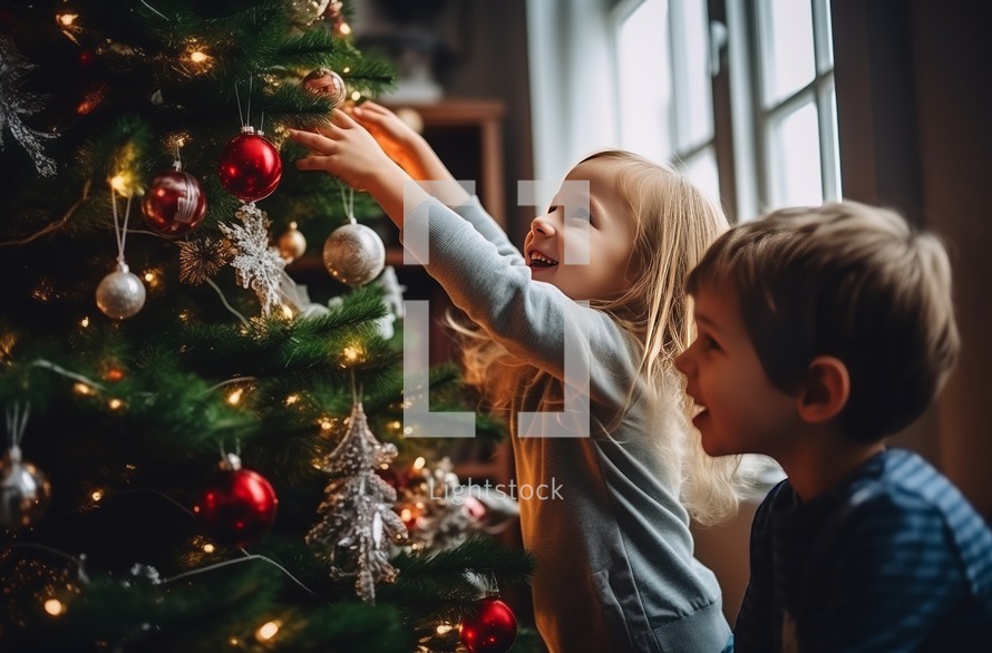 A boy and a girl happily decorating a Christmas tree with ornaments