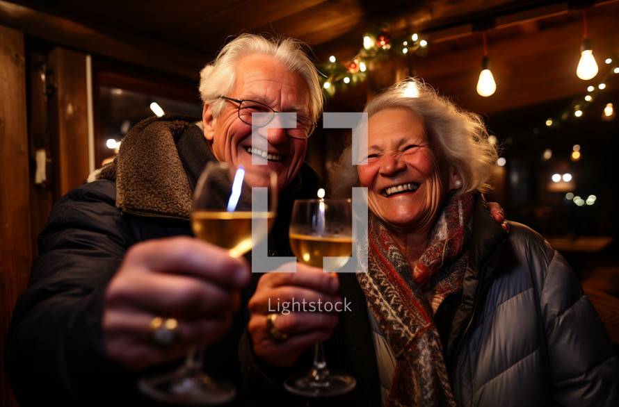 Elderly caucasian couple clinking wine glasses at a Christmas event