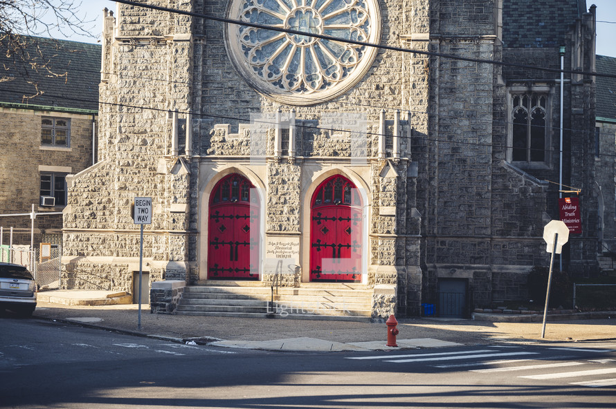 stone church in a city with red doors 