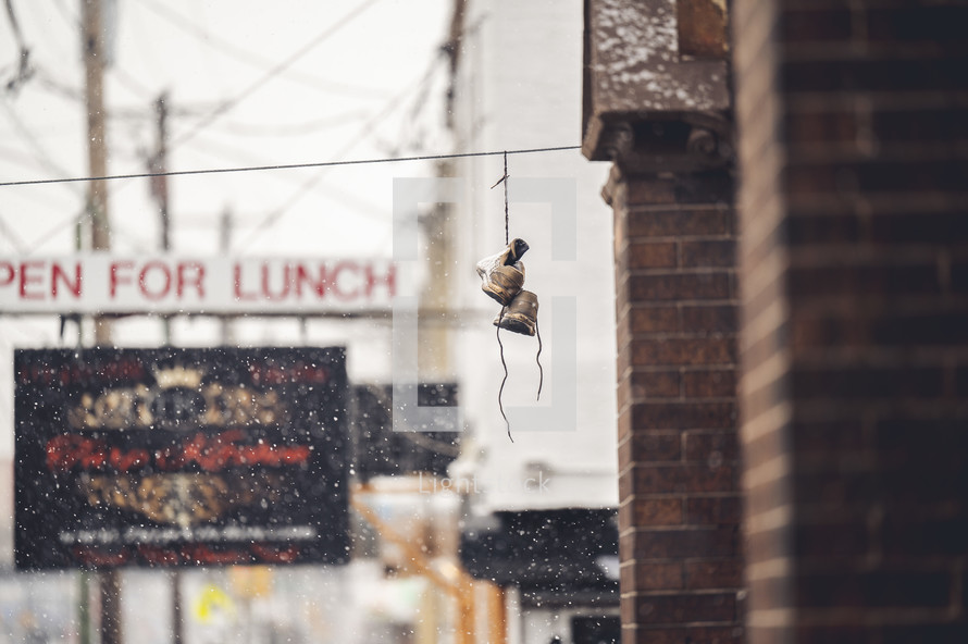 shoes hanging from a power line in a city 
