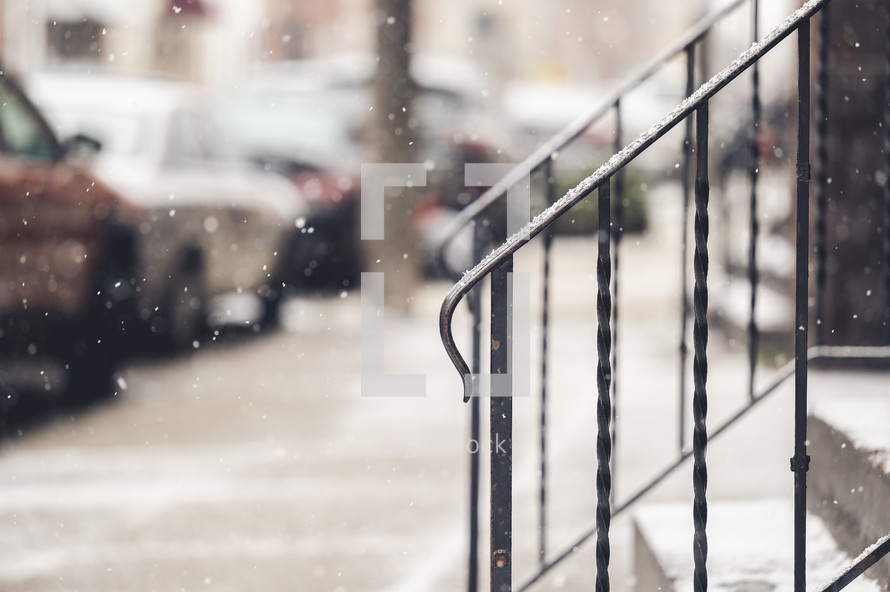 falling snow on a city sidewalk 