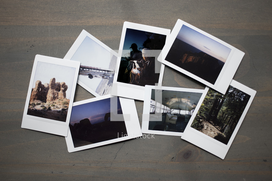 Group of Travel Polaroid Film Photographs Lay on Wooden Table