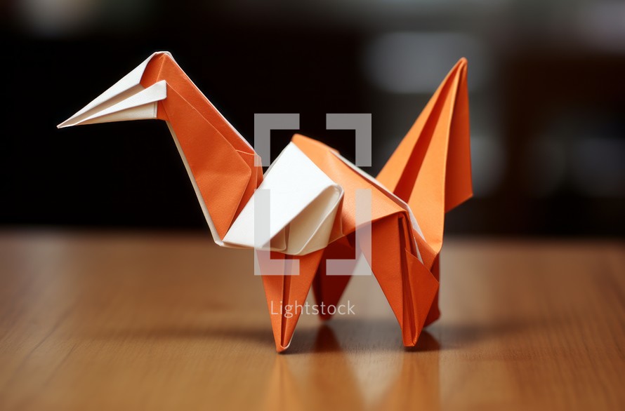 A close-up view of an origami bird placed on a table, showcasing intricate paper folding artistry