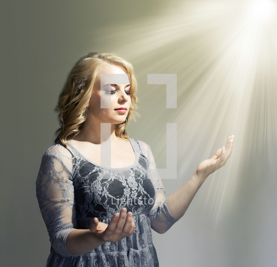 woman standing under heavenly light