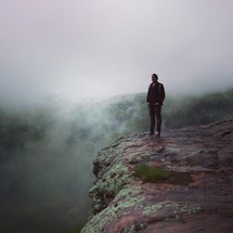 man standing at the edge of a cliff