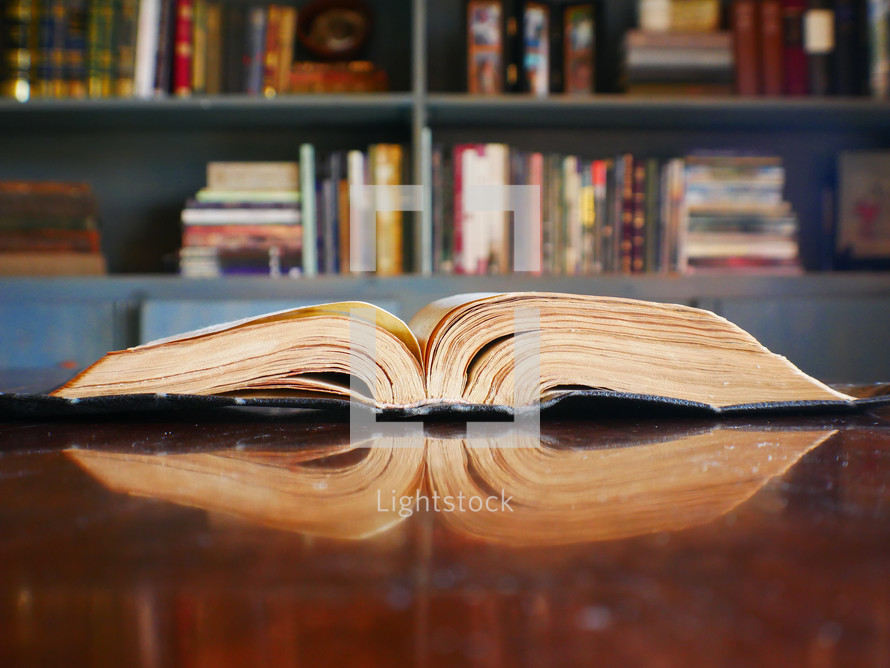an open book on a table in a library 