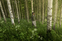 man hiking through a forest 