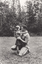 father and daughter hugging outdoors 