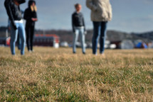 people standing in grass