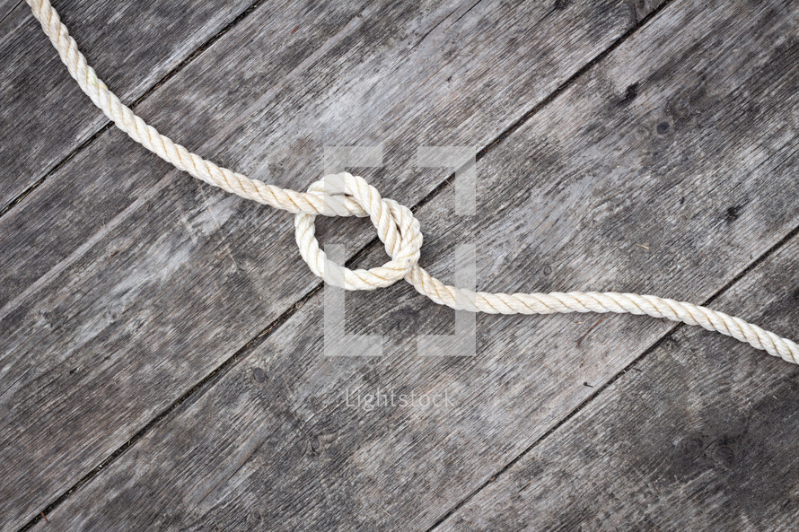 knot in rope on a wood background 