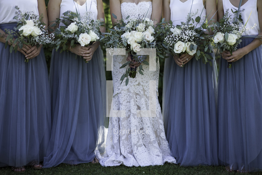 bridesmaids and bride holding bouquets at a wedding 