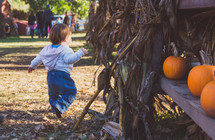 a toddler boy at a pumpkin patch 