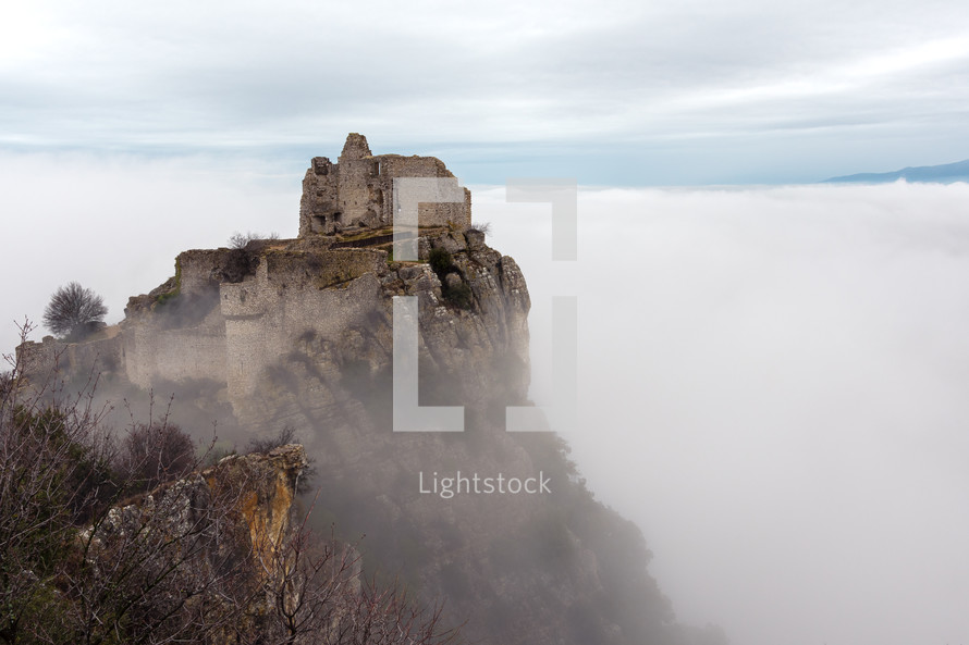 French winter landscapes. Stunning panoramic view of castle ruins Crussol. Foggy mountain landscape