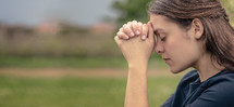 a young woman in prayer