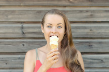 a woman eating an ice cream cone 