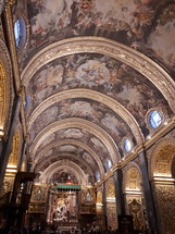 ornate paintings on a cathedral ceiling 