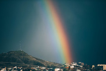 A rainbow in a sunny blue sky