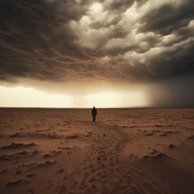 A person walks in the desert under stormy clouds. A lone figure in the distance. Searching for oneself, truth, and purpose in life. Lost in solitude