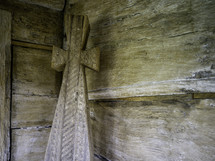 wooden cross on wooden wall
