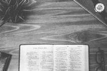 The Psalms, open Bible, Bible, pages, reading glasses, wood table 