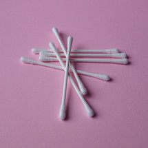 cotton swabs on the pink background