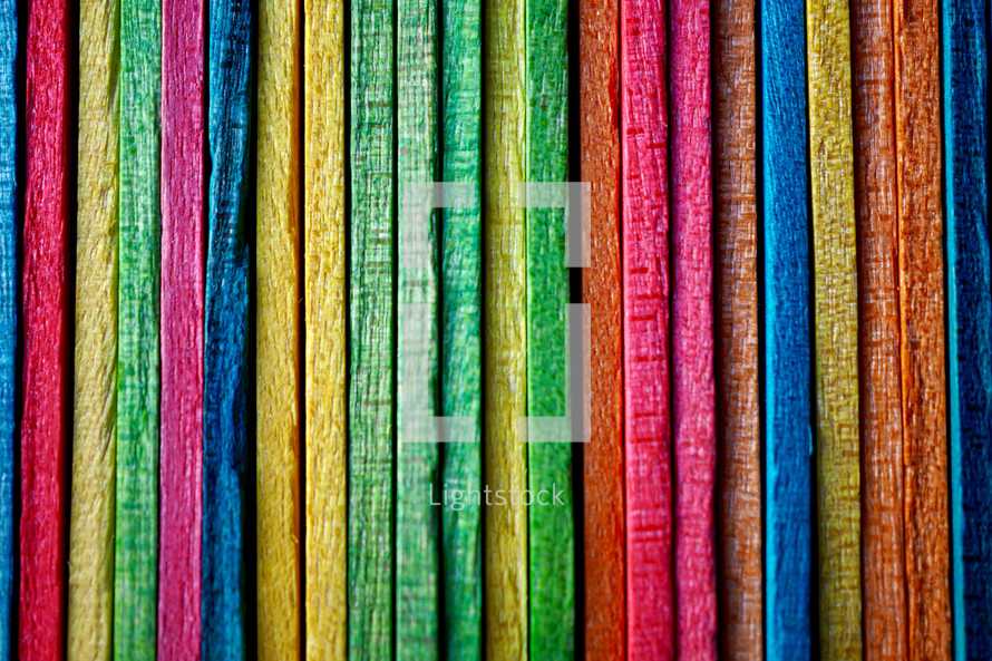 multi colored wooden craft sticks, colorful background