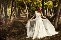 A woman in a white dress in a forest