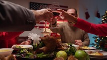 Family cheering and drinking wine to celebrate thanksgiving 