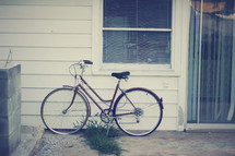 bicycle in front of a window 