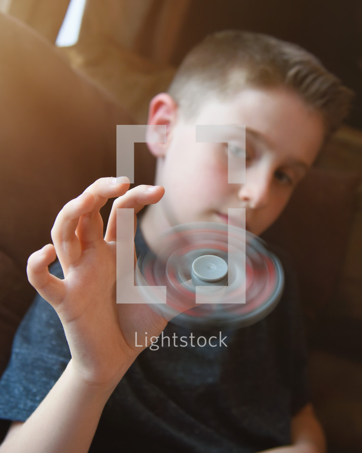 a boy with a fidget spinner 