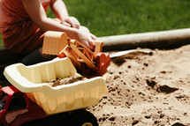 boy playing in a sandbox 