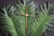 palm fronds and cross on a gray background 