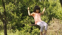 a little girl on a swing 