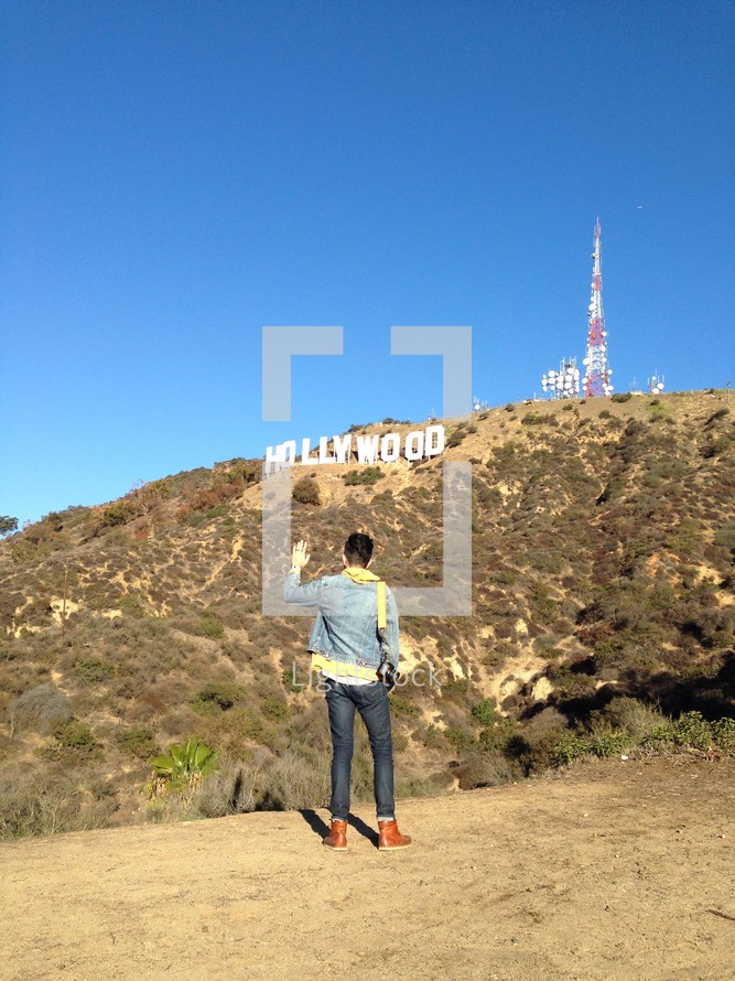 tourist in front of the Hollywood sign 
