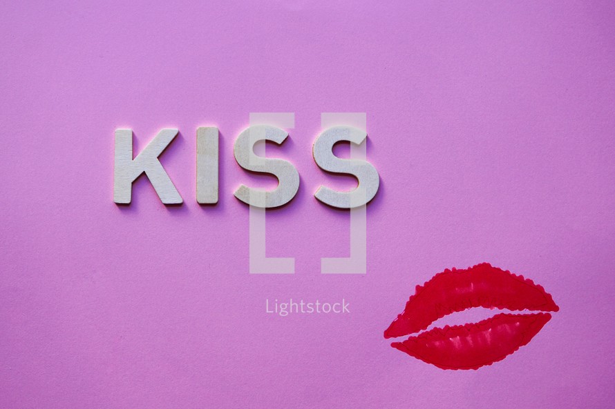 kiss word  and lips on the pink background