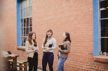 young women in a women's group holding Bibles 