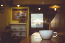 coffee mug on a countertop in a coffee shop 