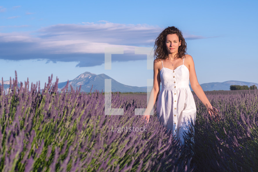 woman walking through a field of lavender 