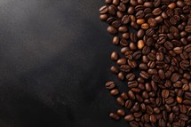 Coffee beans on a black background with copy space. Top view.