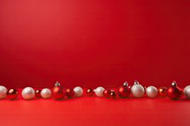 Christmas background with red and silver balls on red background with copy space