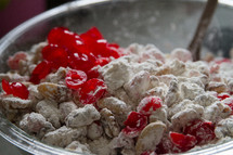 sticking cranberries and powdered sugar in a bowl 
