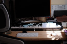 Creative musician workspace with keyboard and sunlight