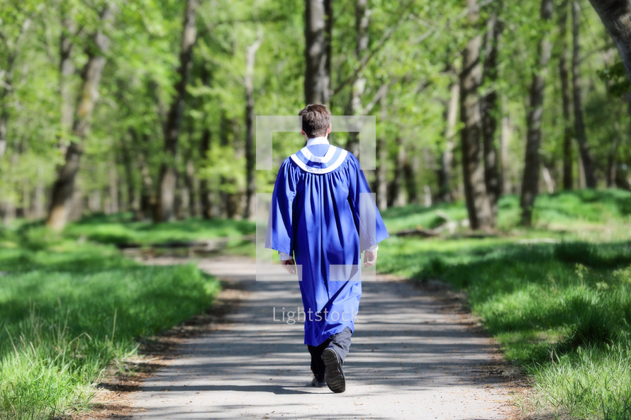 graduate walking on path