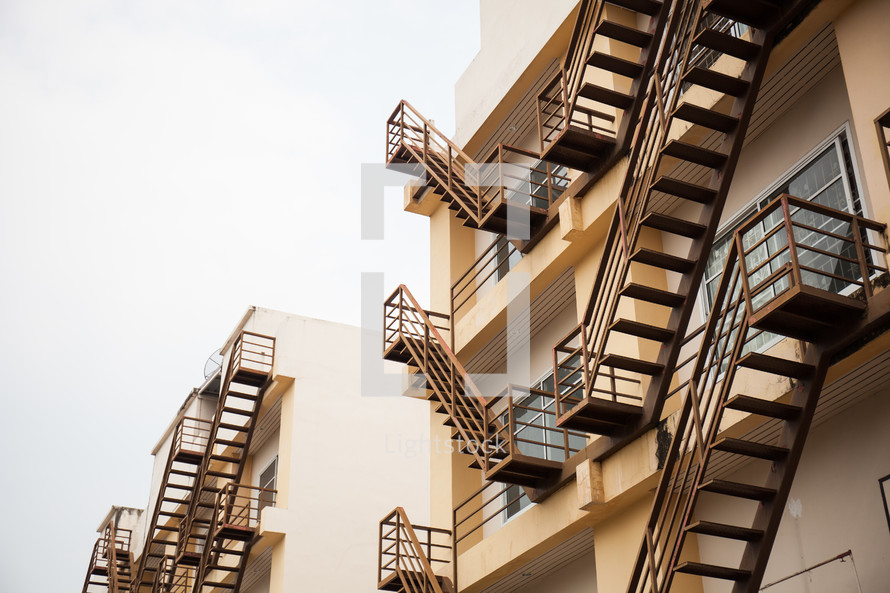 fire escapes on the side of an apartment building 