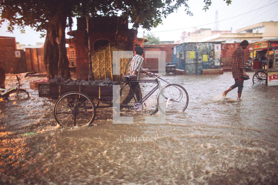 People walking through the flooded streets of India. 